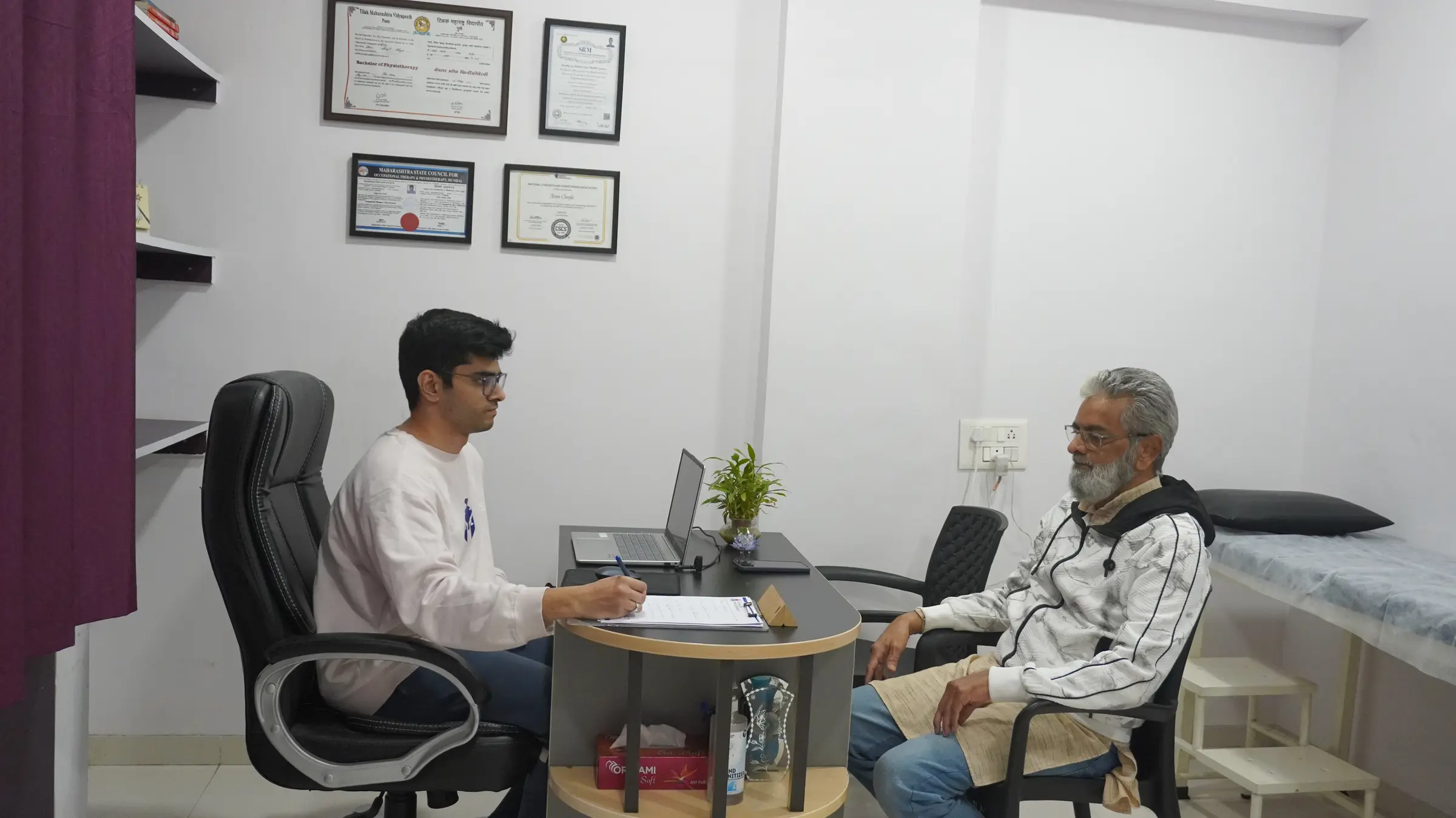 Physiotherapist consulting with a patient