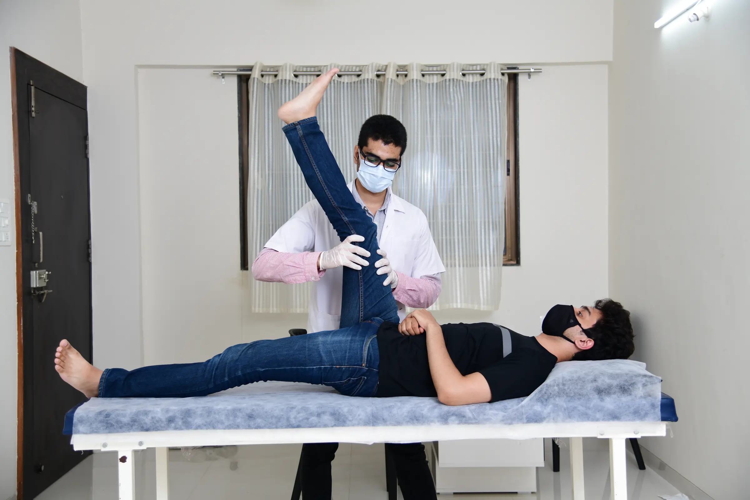 Physiotherapist assessing leg mobility